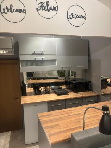a kitchen with two logos on the wall at Studio Old Town in Maribor