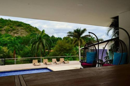 a balcony of a house with a swimming pool at Magnifica finca santa fe de Antioquia in Santa Fe de Antioquia