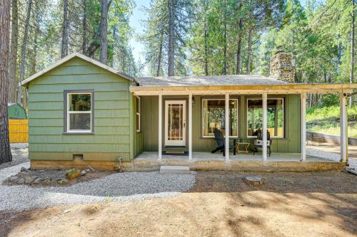 a green tiny house in the woods at Walk to Winery Cozy Cabin with Fire Pit in Murphys in Murphys