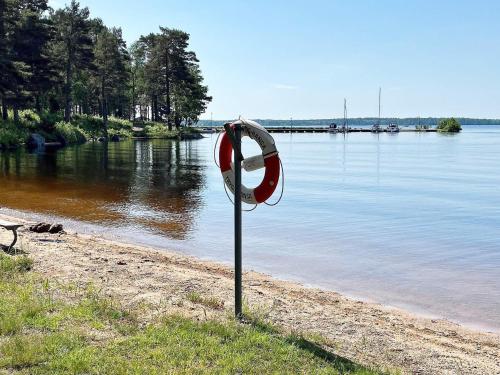 a life preserver on the shore of a body of water at 5 person holiday home in MÖLLTORP-By Traum in Mölltorp