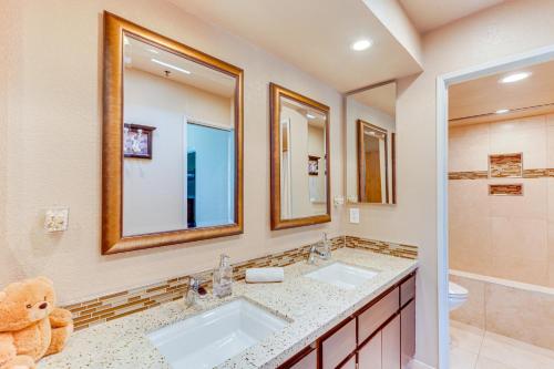 a bathroom with two sinks and a teddy bear at Community Pool Access Chic Palm Springs Condo in Palm Springs