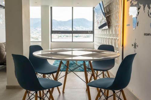 a table and chairs in a room with a window at Acapulco Retreat with Bay Views & Amenities in Acapulco