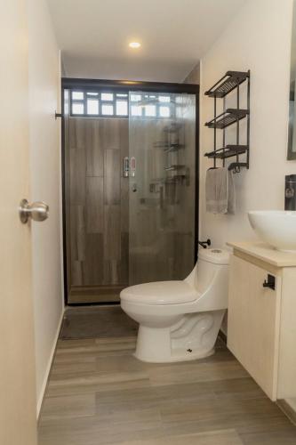 a bathroom with a shower and a toilet and a sink at Acapulco Retreat with Bay Views & Amenities in Acapulco