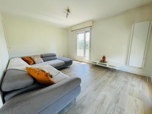 un salon avec un canapé et une fenêtre dans l'établissement NK House, à Annemasse