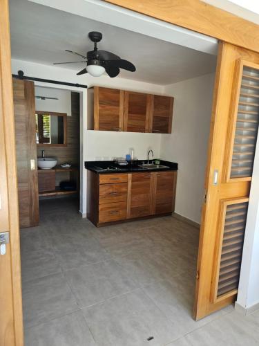 an empty kitchen with a sink and a ceiling fan at Casa Shambala B&B in Las Terrenas