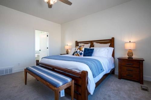 a bedroom with a large bed with a blue and white comforter at Powder Ridge Escape with Hot Tub in Eden