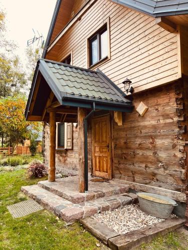 a house with an awning on the side of it at Dom w krainie Bugu in Korczew