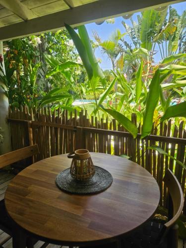 a wooden table with a vase sitting on top of it at Casa Shambala B&B in Las Terrenas