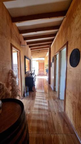 a hallway in a house with wooden walls and a wooden floor at Casa de Campo para desconectarse de la ciudad in Rancagua