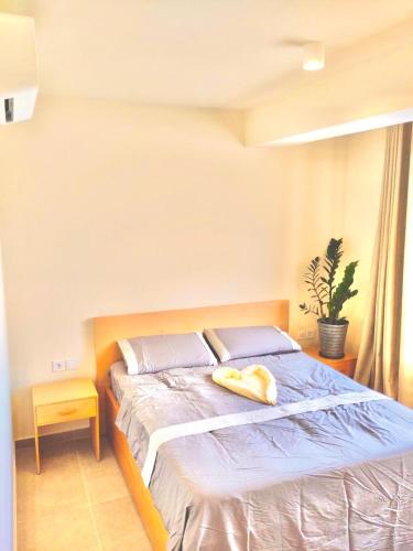 a bedroom with a bed with a yellow towel on it at Stylish Lagoon Paradise Apartment Boa Vista in Sal Rei