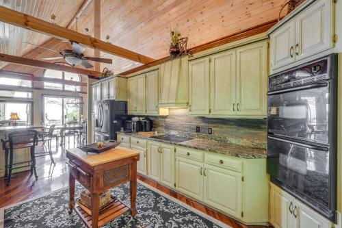 a kitchen with green cabinets and a wooden ceiling at Stunning Hiawassee Hideaway with Impeccable Views! in Hiawassee
