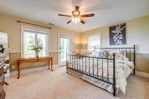 a bedroom with a bed and a ceiling fan at Stunning Hiawassee Hideaway with Impeccable Views! in Hiawassee