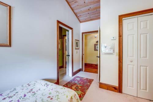 a bedroom with a bed and a mirror at Stunning Hiawassee Hideaway with Impeccable Views! in Hiawassee