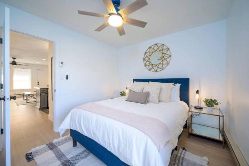 a bedroom with a large bed with a ceiling fan at Mountainside Ski & Golf Retreat in Eden