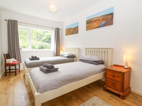 a bedroom with two beds and a window at The Headland in Amlwch