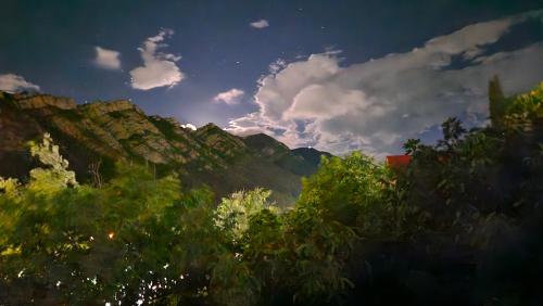 a view of a mountain range with clouds and trees at Guesthouse in Mtskheta K2 #2 in Mtskheta