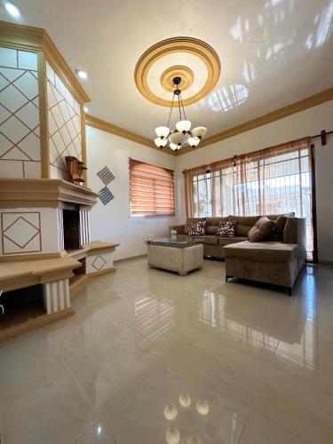 a living room with a couch and a ceiling at Cerca del divino niño I WiFi I TV in Constanza