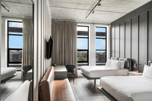 a hotel room with two beds and a balcony at Waymore's Guest House & Casual Club in Nashville