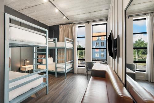 a dorm room with bunk beds and a desk at Waymore's Guest House & Casual Club in Nashville