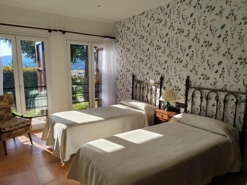 Giường trong phòng chung tại Casa Rural Villa Rosario