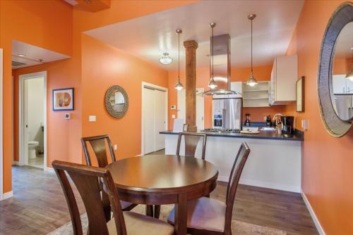 a kitchen and dining room with a wooden table and chairs at VioletSuitesPDX Boutique Hotel in Portland