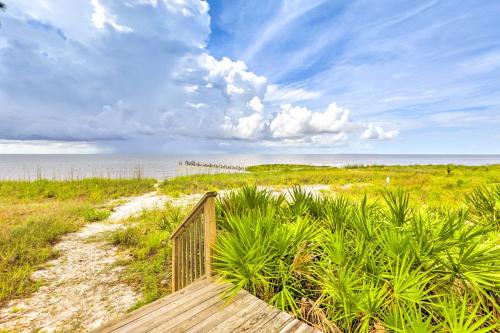 a wooden path to the beach with a cloudy sky at Beach and Pool Access Peaceful St Teresa House in Big Blackjack Landing