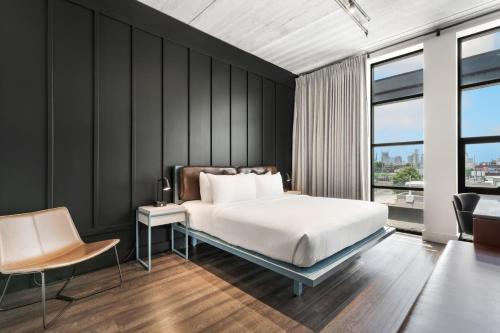 a bedroom with a bed and a desk with a chair at Waymore's Guest House & Casual Club in Nashville