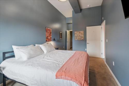 a bedroom with a large bed with white sheets at VioletSuitesPDX Boutique Hotel in Portland