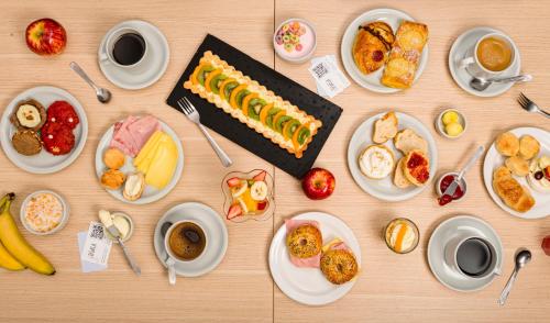 a table with a cake and plates of food at Hotel Traful in Mar del Plata