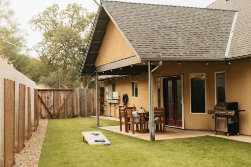 a patio with a grill and a house at Good Girl's Peak Paradise with bbq and fire pit in Mariposa