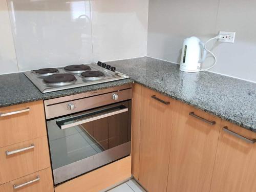 a kitchen with a stove and a counter top at Mactan Newtown 2 Bedrooms Suite in Lapu Lapu City