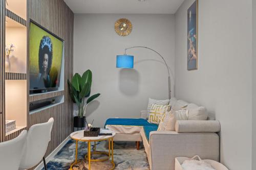 a living room with a couch and a table at Meriweather - Calgary Breathtaking 1-bedroom apartment in Calgary