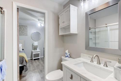 a bathroom with a sink and a toilet and a mirror at Cozy Home Near Downtown Lawton in Lawton