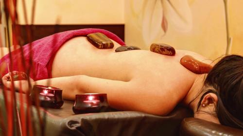 a pregnant woman laying in a chair with candles at Park Hotel Kur & Spa in Świeradów-Zdrój