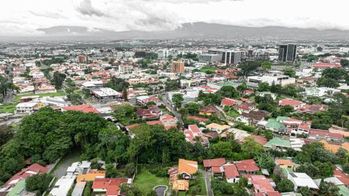 an aerial view of a city with buildings and trees at Home 333 habitacion 336 in Escazu