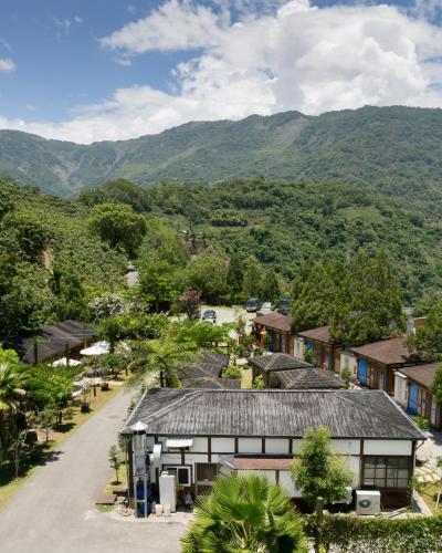 an overview of a village with mountains in the background at Grand Orchid Resort Villa in Liugui