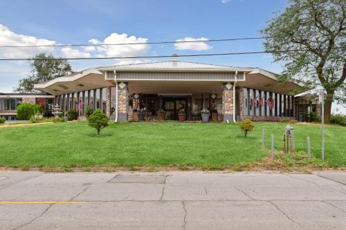 a building with a lawn in front of it at Miami Suites in Toledo