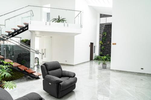 a living room with a chair and a recliner at Home 333 habitacion 336 in Escazu