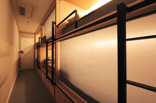 a walk in closet with a sliding glass door at Blueboat Hostel Gyeongju in Gyeongju