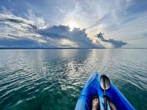 a person on a boat in the water at Bocas Sunset Beach House in Bocas del Toro