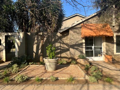a house with a potted plant in front of it at Silken Trap Accommodation NO LOADSHEDDING in Johannesburg