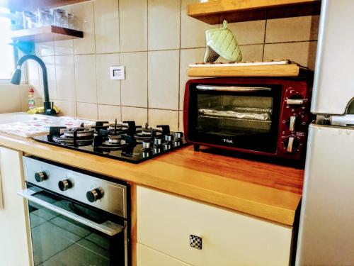 a microwave oven sitting on top of a kitchen counter at Ela in Playa del Carmen