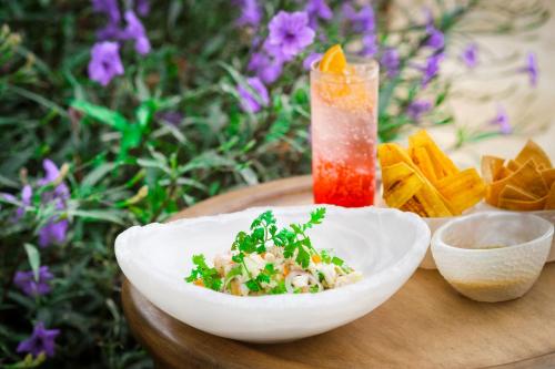 a bowl of food on a table with a drink at Kimpton - Grand Roatan Resort and Spa in West Bay