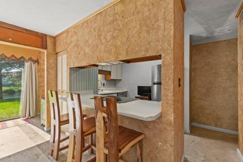 a kitchen and dining room with a table and chairs at Sandy Beaches-3 Pools-Pet Friendly in Destin