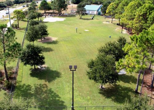 an overhead view of a park with trees and a street light at Sandy Beaches-3 Pools-Pet Friendly in Destin