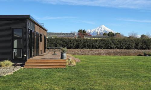 a house with a deck with a snow covered mountain in the background at Peaceful On Pembroke in Stratford