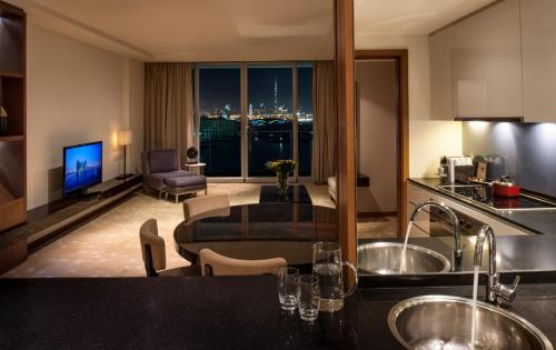 a kitchen and living room with a view of a city at InterContinental Residence Suites Dubai Festival City by IHG in Dubai