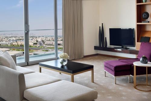 a living room with a couch and a tv at InterContinental Residence Suites Dubai Festival City by IHG in Dubai