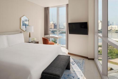 a hotel room with a bed and a large window at InterContinental Residence Suites Dubai Festival City by IHG in Dubai