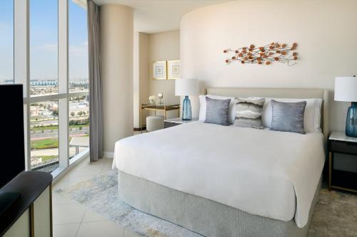 a bedroom with a large white bed and a large window at InterContinental Residence Suites Dubai Festival City by IHG in Dubai